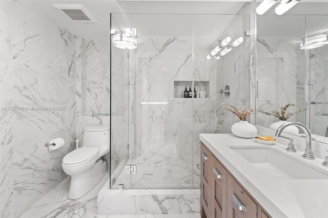 bathroom with vanity, a shower with shower door, and toilet