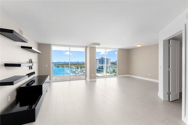 10 Venetian Way Unit 1903, Miami Beach, FL 33139 - unfurnished living room with a water view, a city view, and light wood-style floors
