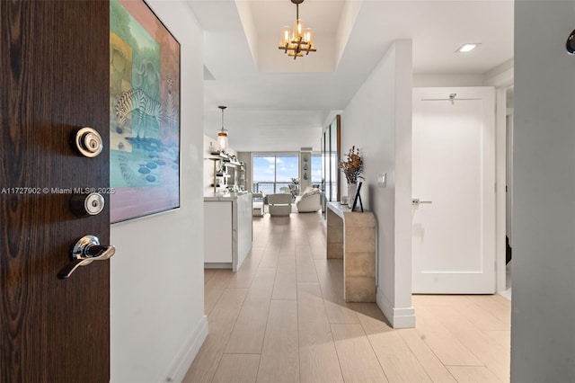 entrance foyer featuring a chandelier and light hardwood / wood-style flooring