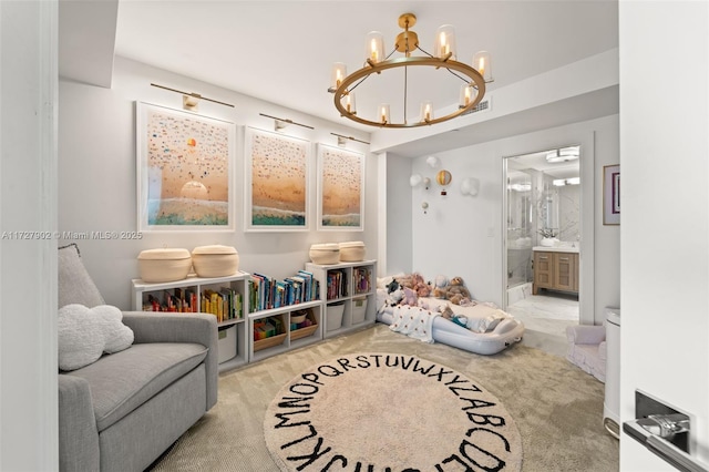 recreation room featuring light colored carpet and a chandelier