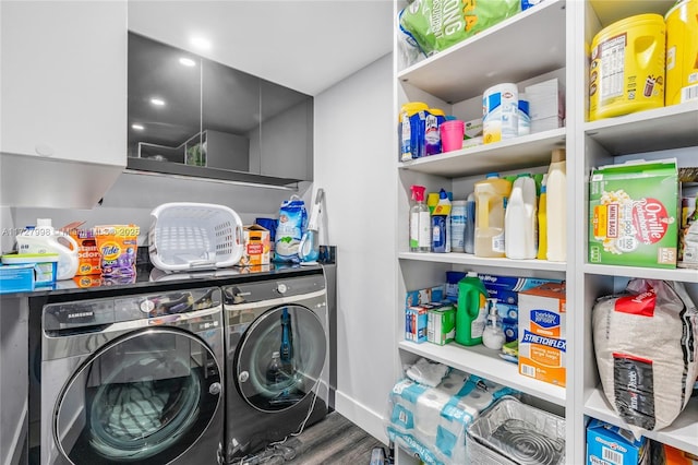 laundry room featuring hardwood / wood-style floors and washing machine and clothes dryer