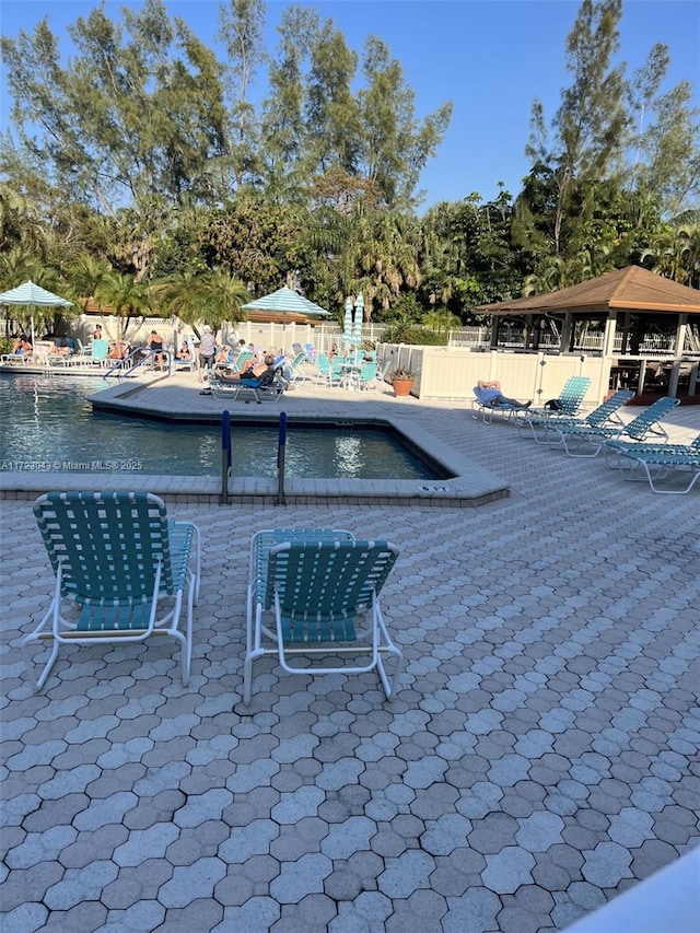 view of patio / terrace featuring a gazebo and a community pool