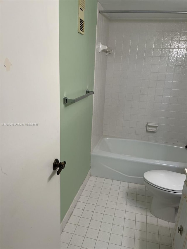 full bathroom featuring toilet, vanity, tiled shower / bath combo, and tile patterned flooring