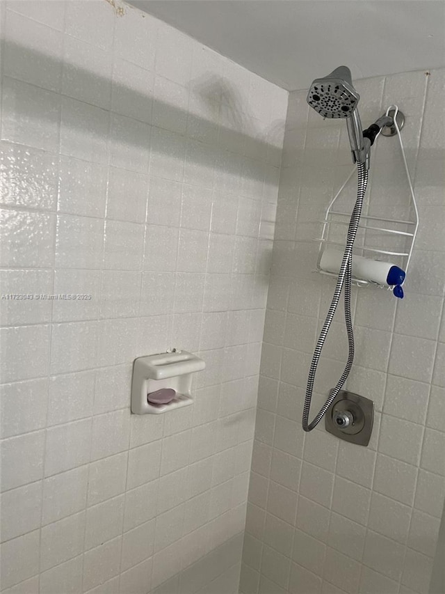 bathroom with a tile shower