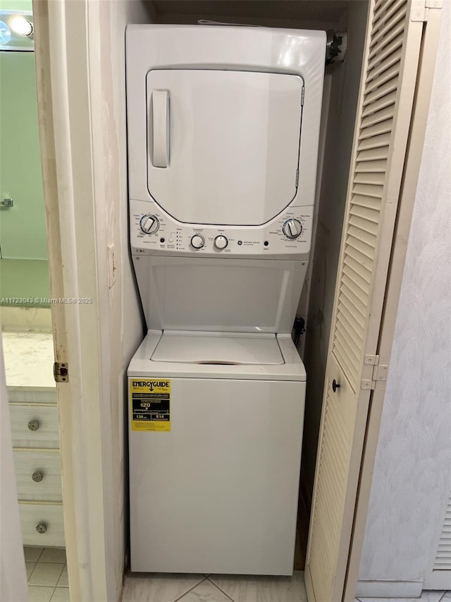 clothes washing area with stacked washer / drying machine