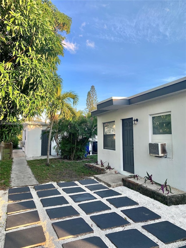 view of front of house featuring cooling unit and a patio