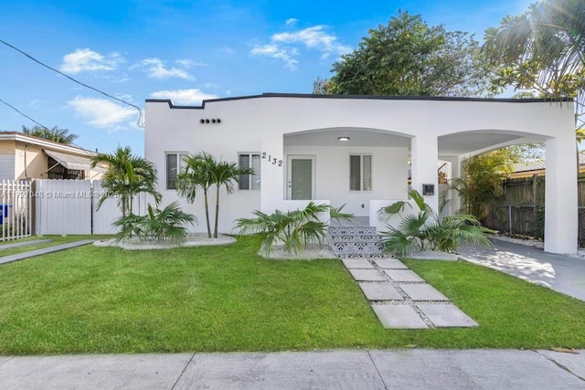 view of front facade with a front yard and a carport