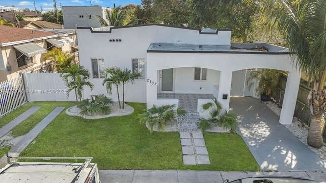 rear view of property with a yard and a carport