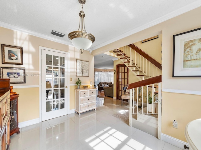 tiled dining area featuring a textured ceiling, crown molding, and french doors