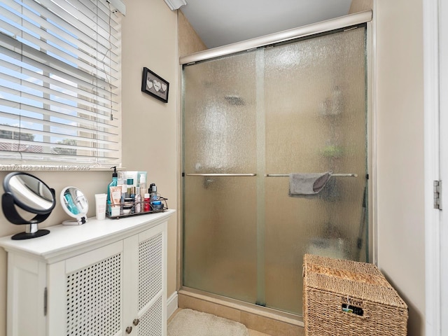 bathroom with a shower with door