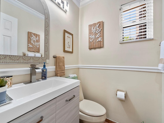 bathroom featuring toilet, crown molding, and vanity