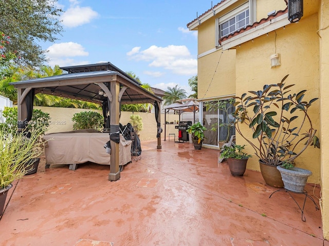 view of patio featuring grilling area and a gazebo