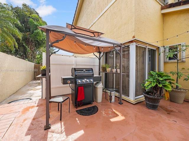 view of patio featuring a lanai and area for grilling