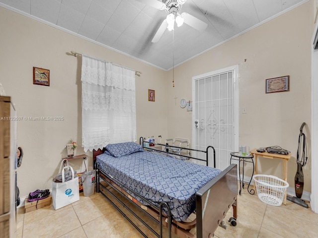 tiled bedroom with ceiling fan and ornamental molding