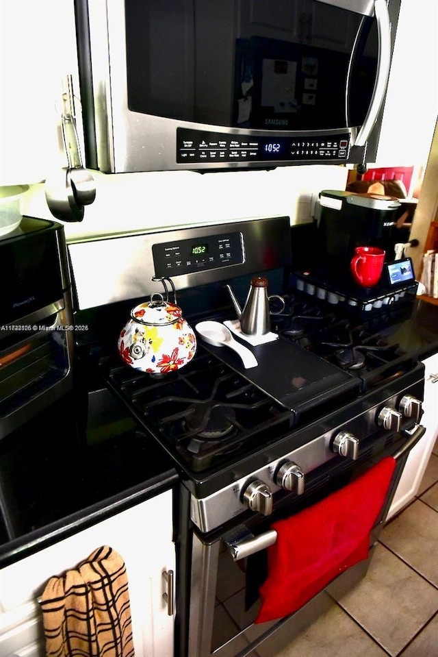 kitchen featuring tile patterned flooring and stainless steel appliances