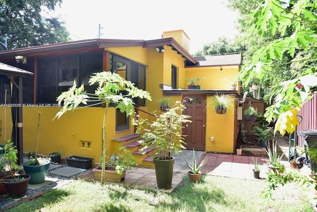 back of house with a sunroom