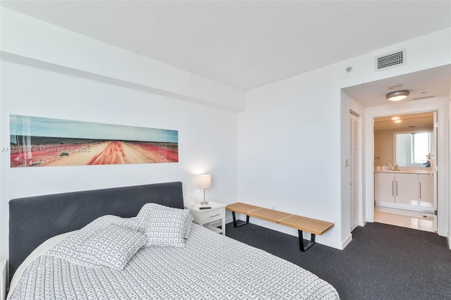 bedroom featuring carpet and connected bathroom