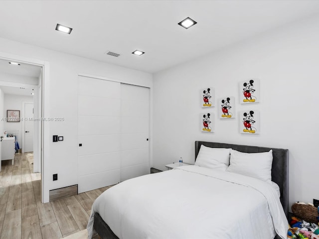 bedroom featuring light wood-type flooring and a closet