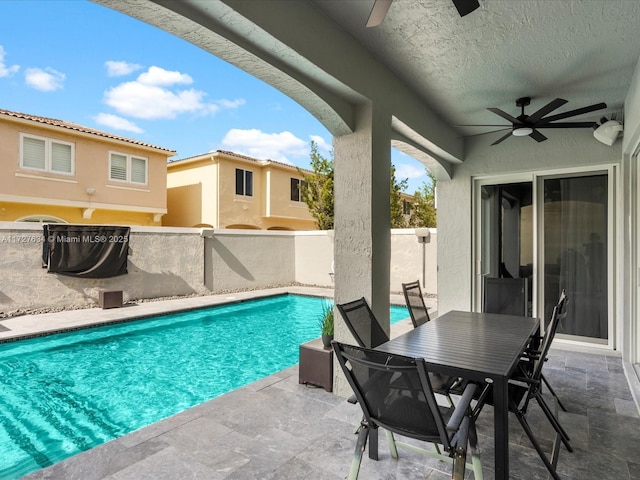 view of pool featuring ceiling fan and a patio