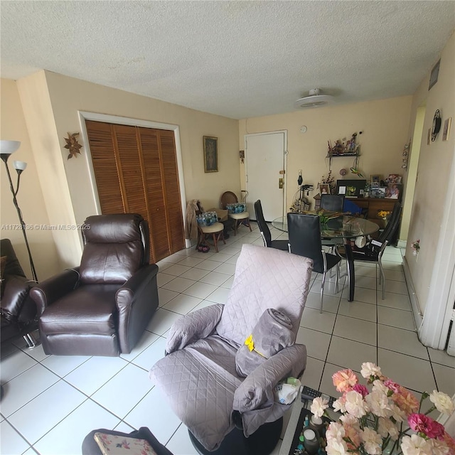 living room with light tile patterned floors and a textured ceiling