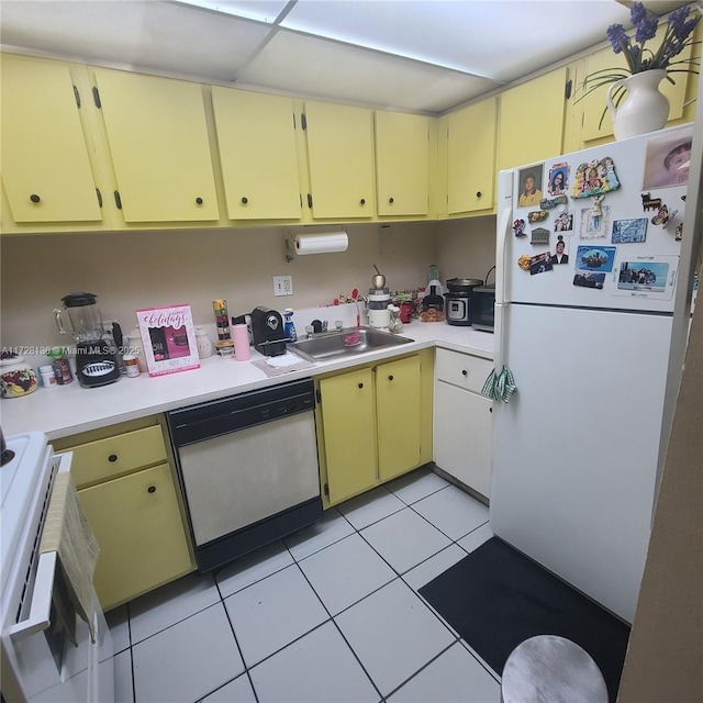 kitchen featuring sink, white appliances, and light tile patterned flooring