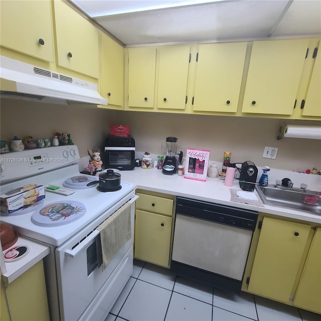 kitchen with sink, light tile patterned floors, and white appliances