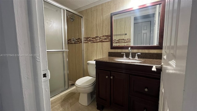 bathroom featuring toilet, tile patterned floors, walk in shower, crown molding, and vanity