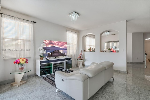 living room featuring a wealth of natural light and a chandelier