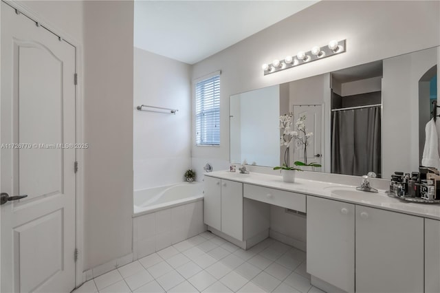 bathroom with vanity, tile patterned floors, and tiled tub