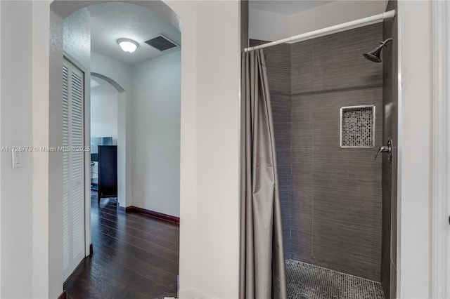 bathroom with a textured ceiling and a shower with curtain