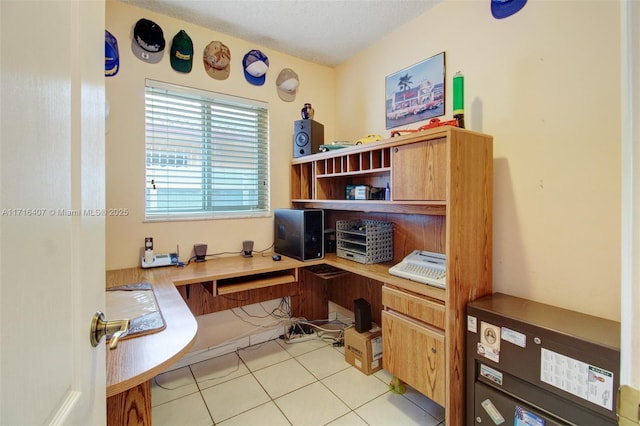 home office featuring a textured ceiling, built in study area, and light tile patterned flooring