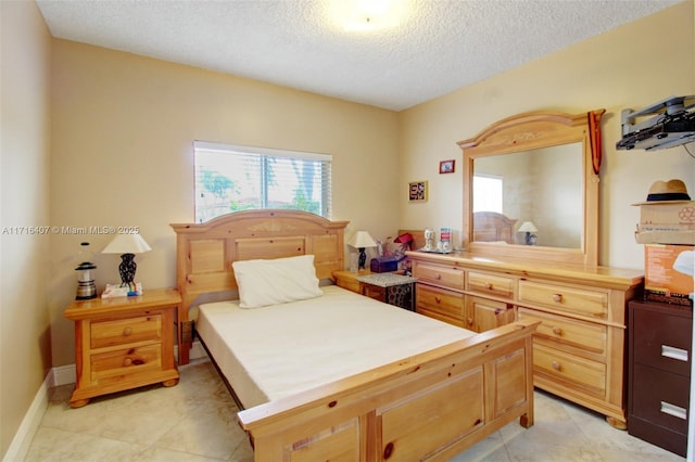 bedroom featuring a textured ceiling and baseboards