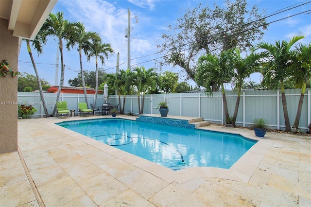 view of pool featuring a patio area, a fenced backyard, and a fenced in pool