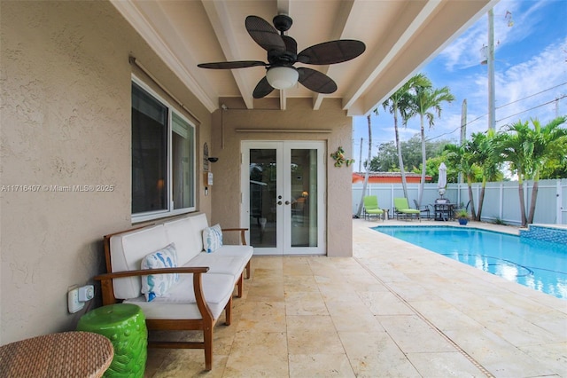 view of pool with a patio, a fenced backyard, a ceiling fan, french doors, and a fenced in pool