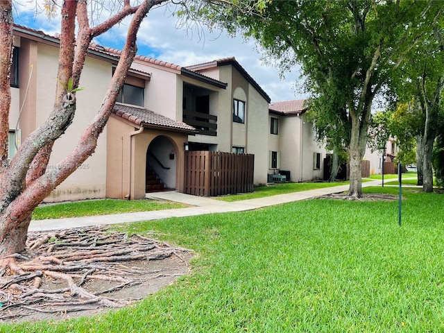 rear view of property featuring a lawn