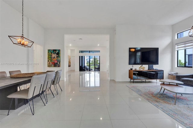 dining space featuring light tile patterned floors and a notable chandelier