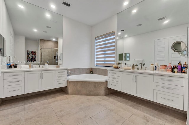 bathroom featuring vanity, tile patterned floors, and plus walk in shower