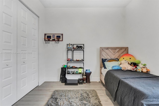 bedroom featuring light wood-style flooring and baseboards