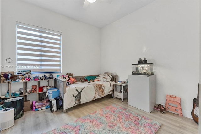 bedroom with light wood-type flooring and ceiling fan