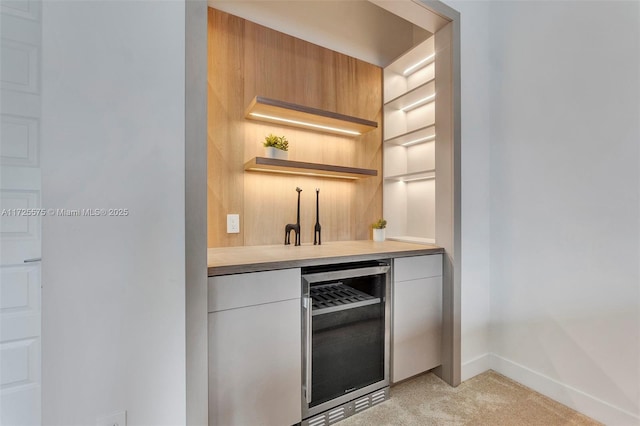 bar featuring light carpet and wine cooler