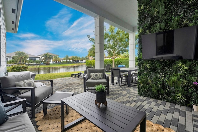 view of patio featuring a water view and outdoor lounge area