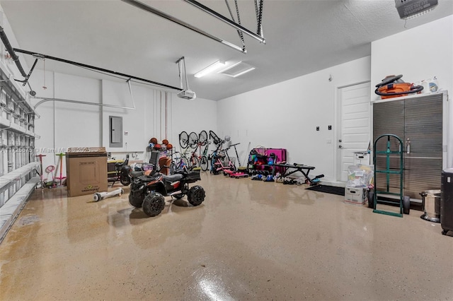 garage with a garage door opener and electric panel