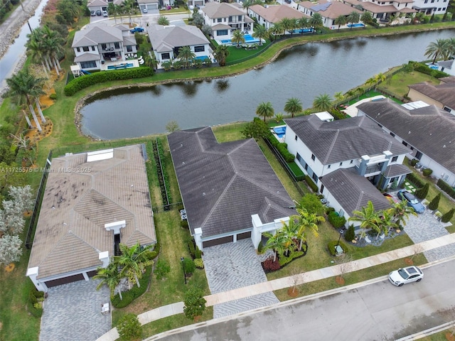 drone / aerial view with a water view and a residential view