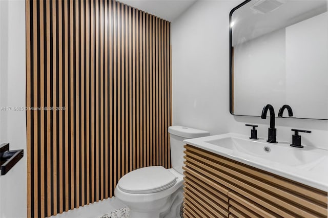 bathroom with toilet and vanity