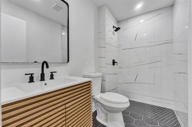 bathroom with vanity, toilet, tile patterned flooring, and walk in shower