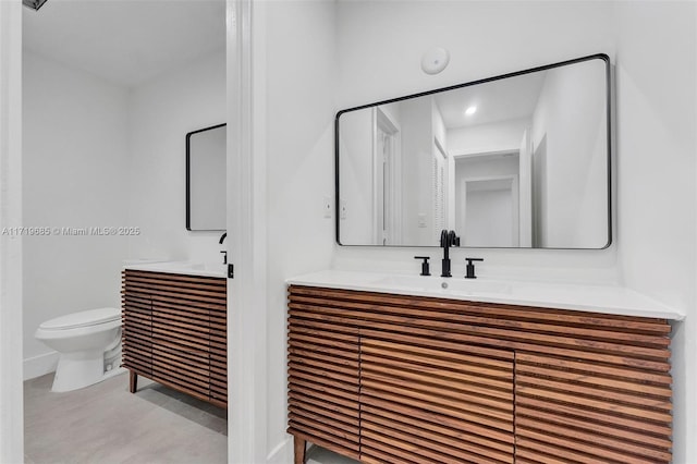 bathroom featuring toilet and vanity