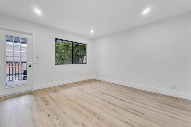 unfurnished room with light hardwood / wood-style floors