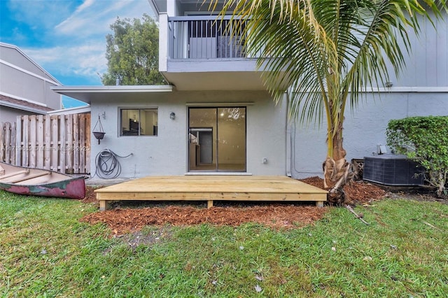 back of property with central AC unit and a yard