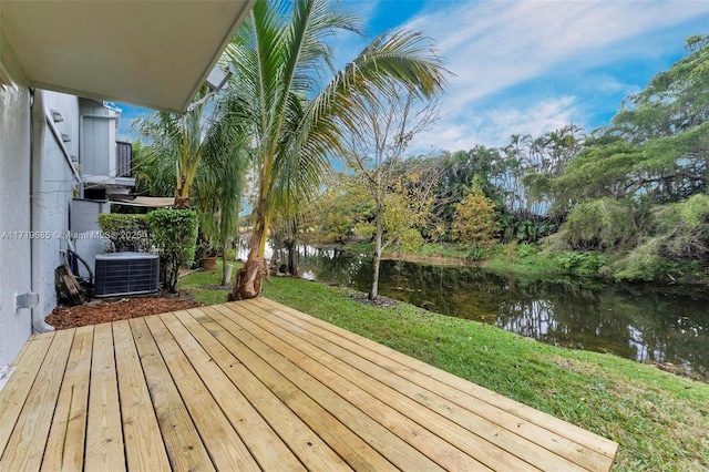 deck featuring a water view, central AC, and a lawn