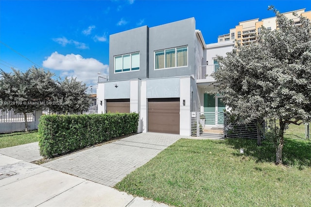 contemporary house with a garage and a front yard